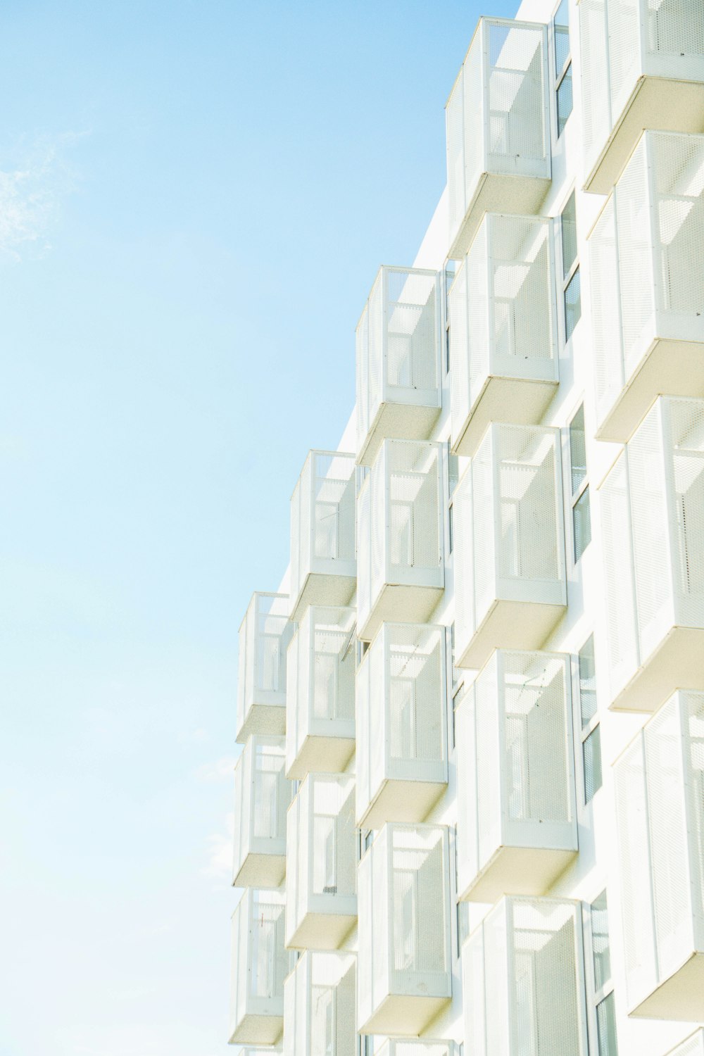 a tall white building with lots of windows