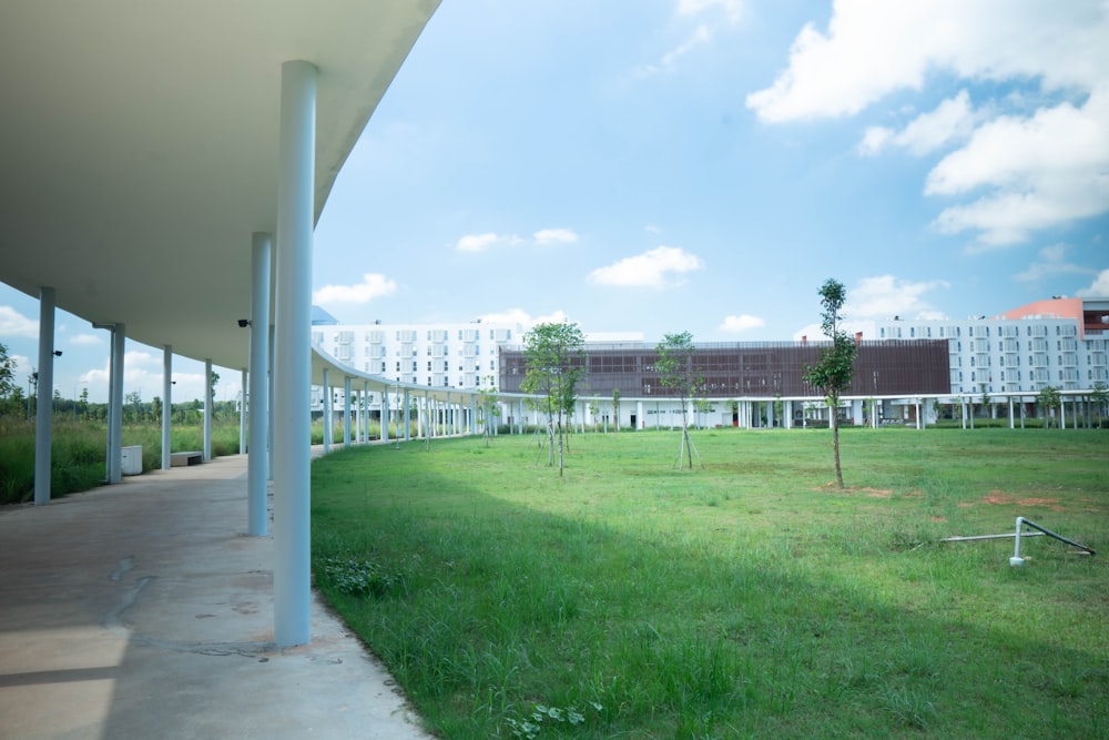 a grassy field with a building in the background