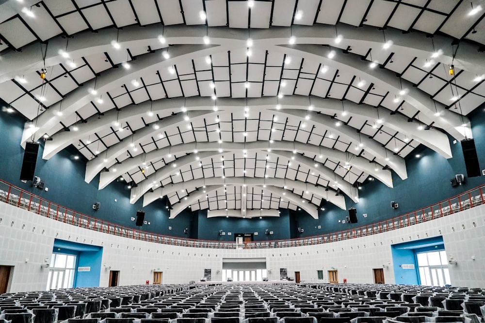 a large auditorium with rows of seats and a ceiling