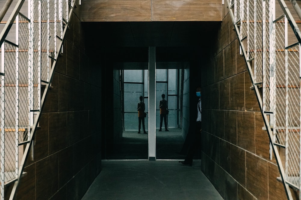 a person standing in a hallway between two walls