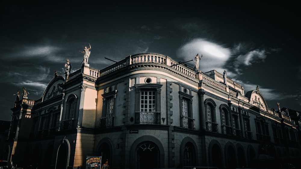 a large building with statues on top of it