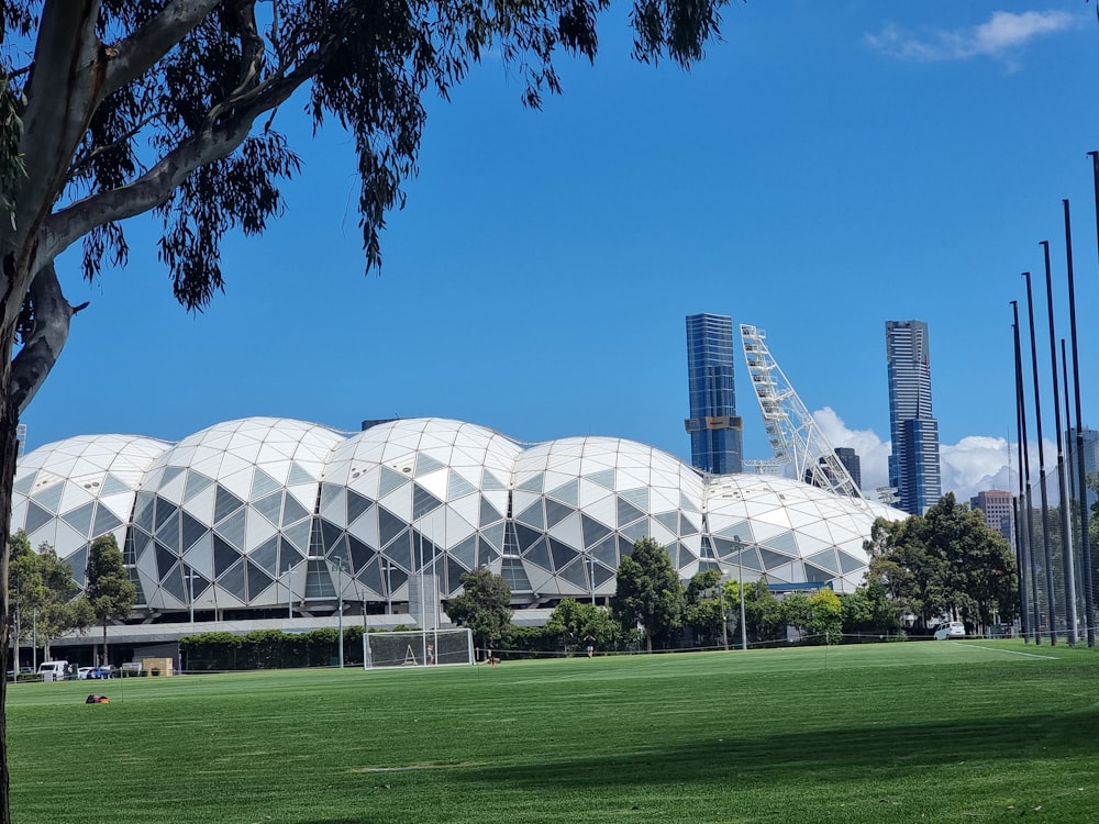 a soccer field with a large building in the background