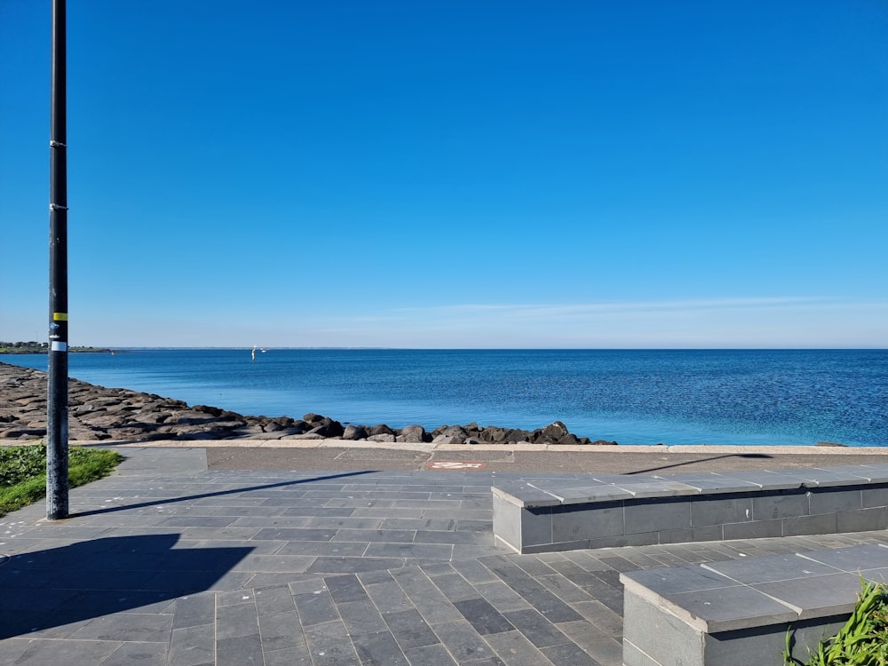 a couple of benches sitting next to a body of water