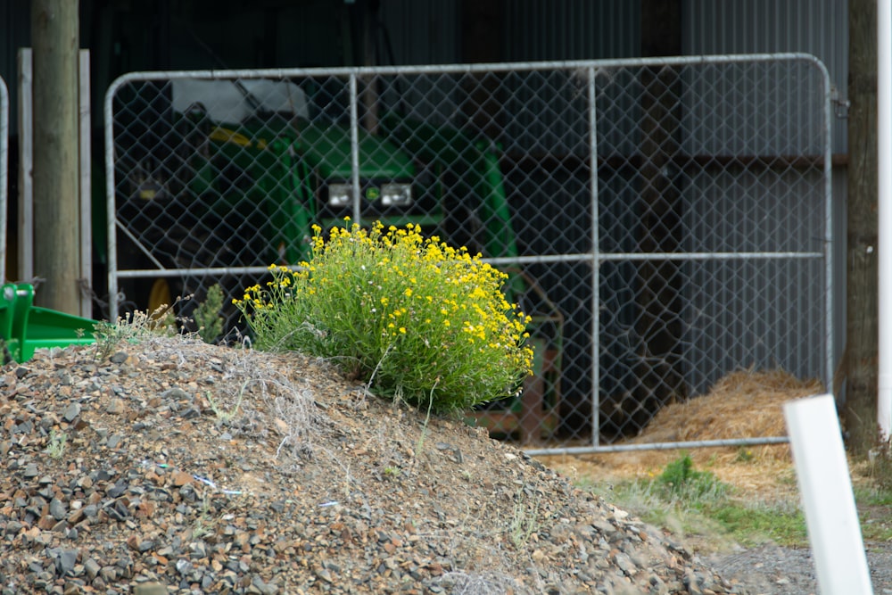 a large pile of dirt next to a fence