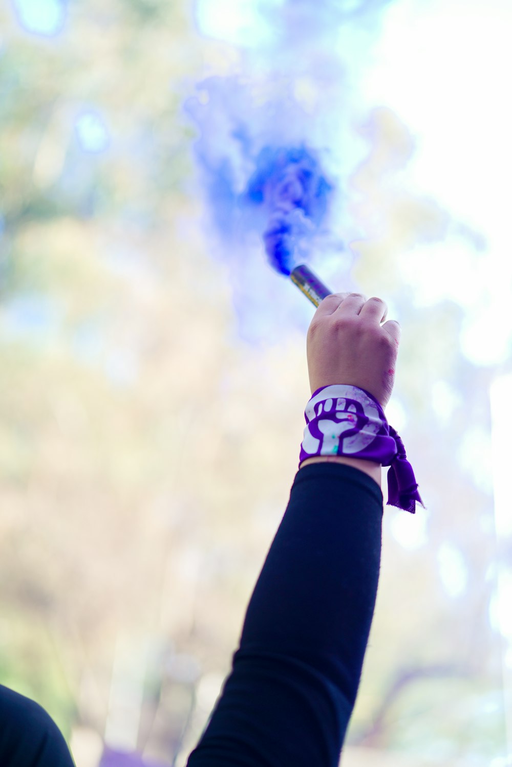 a person holding a purple and white object in their hand