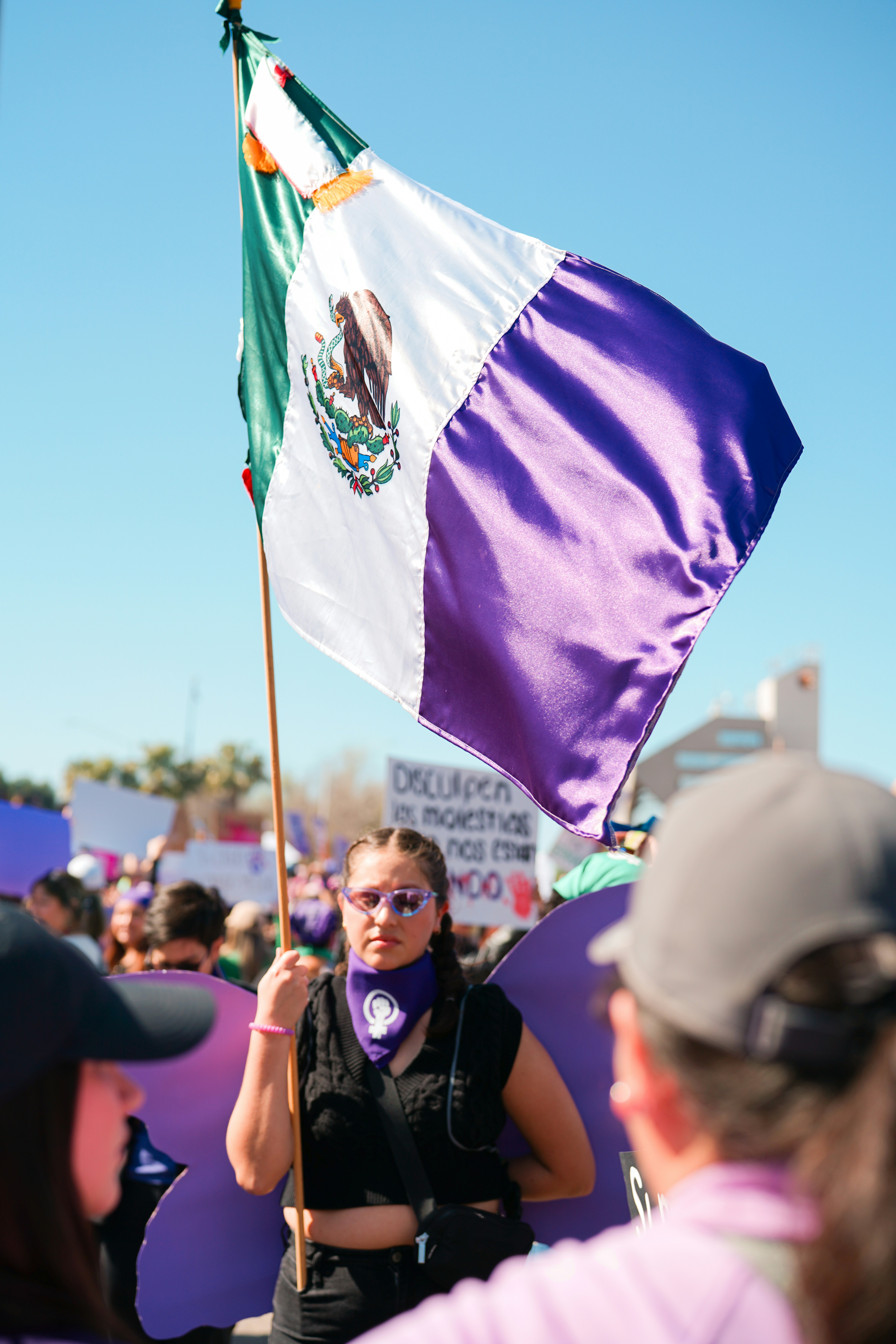 a woman holding a flag in a crowd