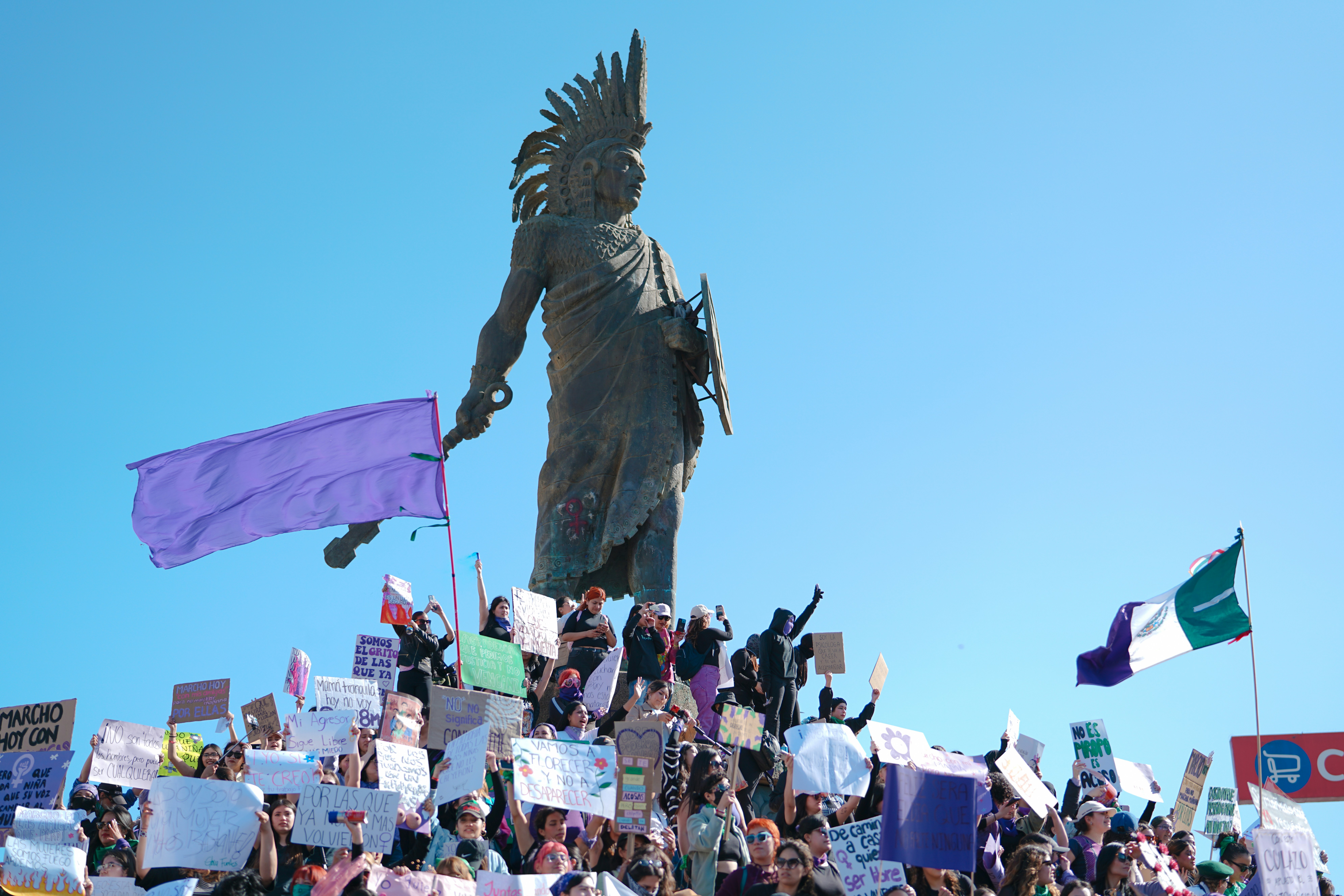 a crowd of people standing around a statue