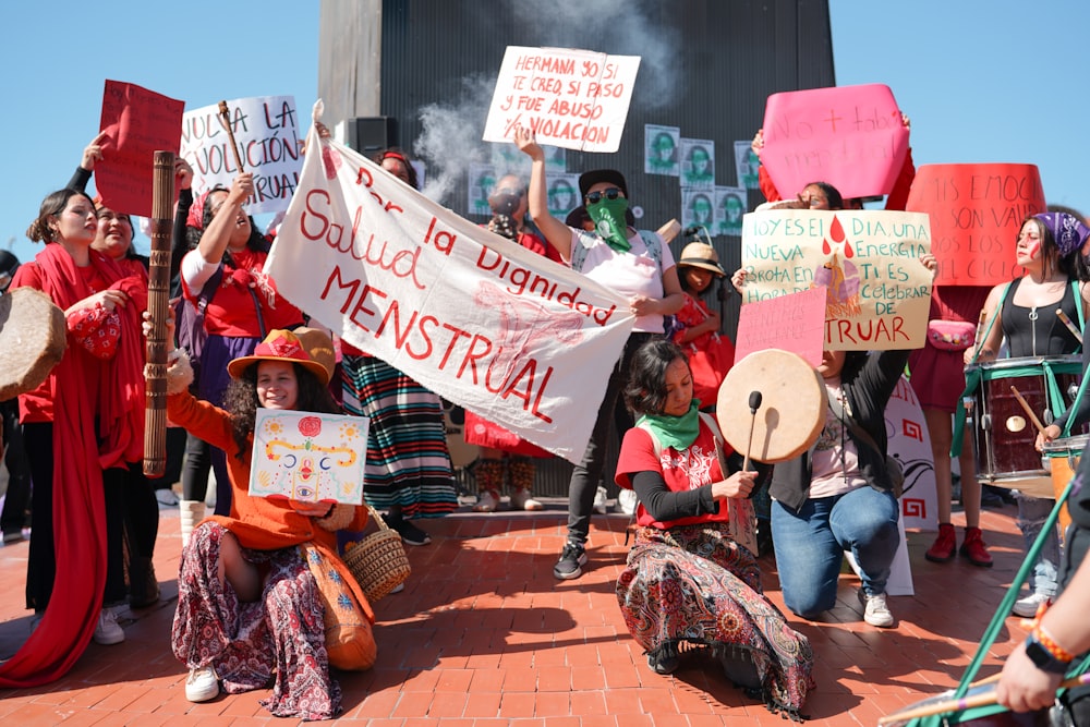 a group of people holding signs and banners