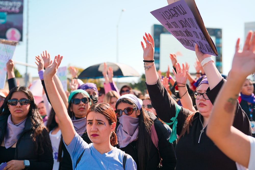 a group of women raising their hands in the air
