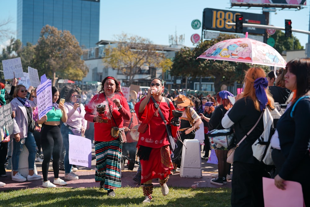 a group of people holding signs and umbrellas