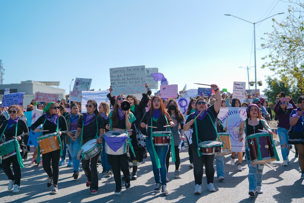 a group of people marching down a street