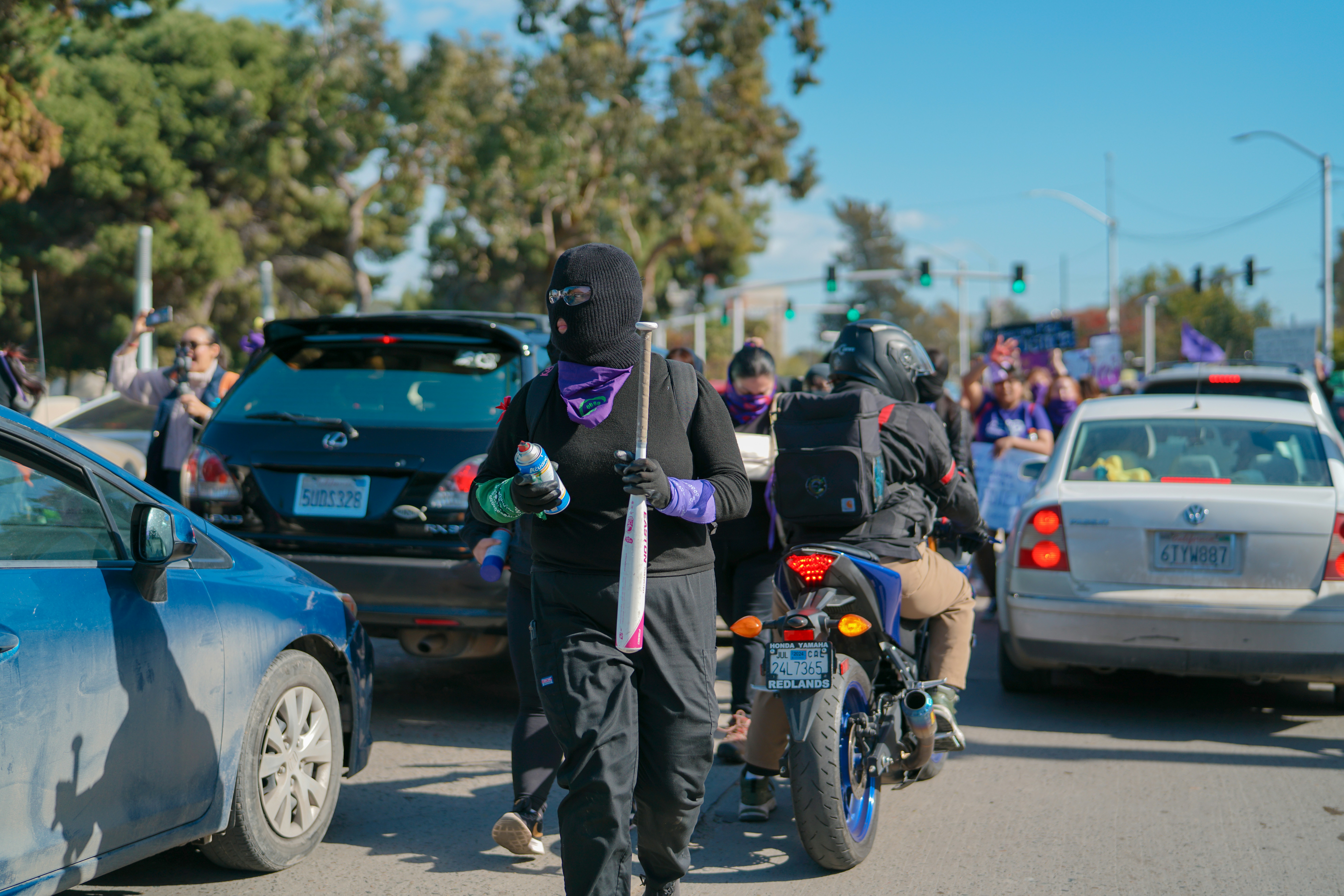 a group of people riding motorcycles down a street