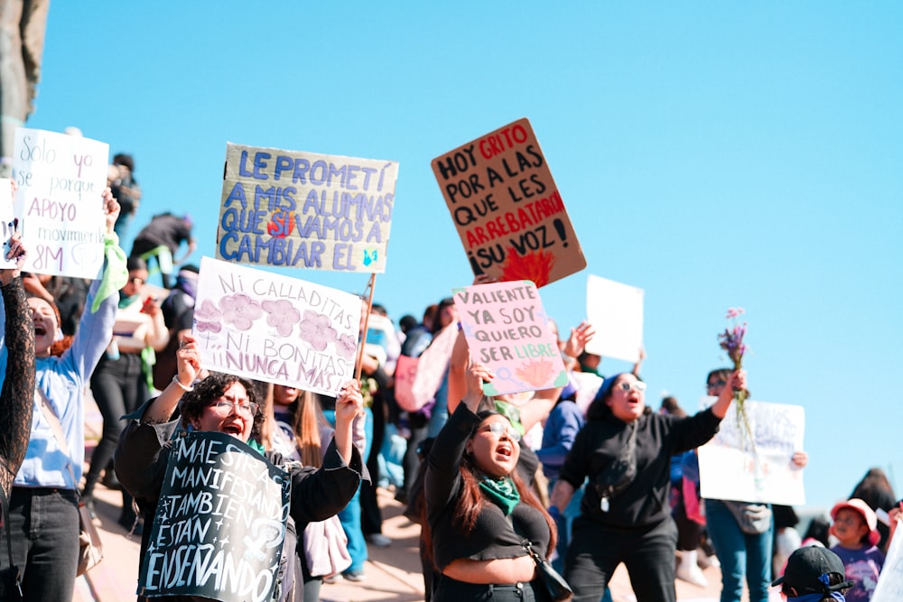 a group of people holding up signs in the air