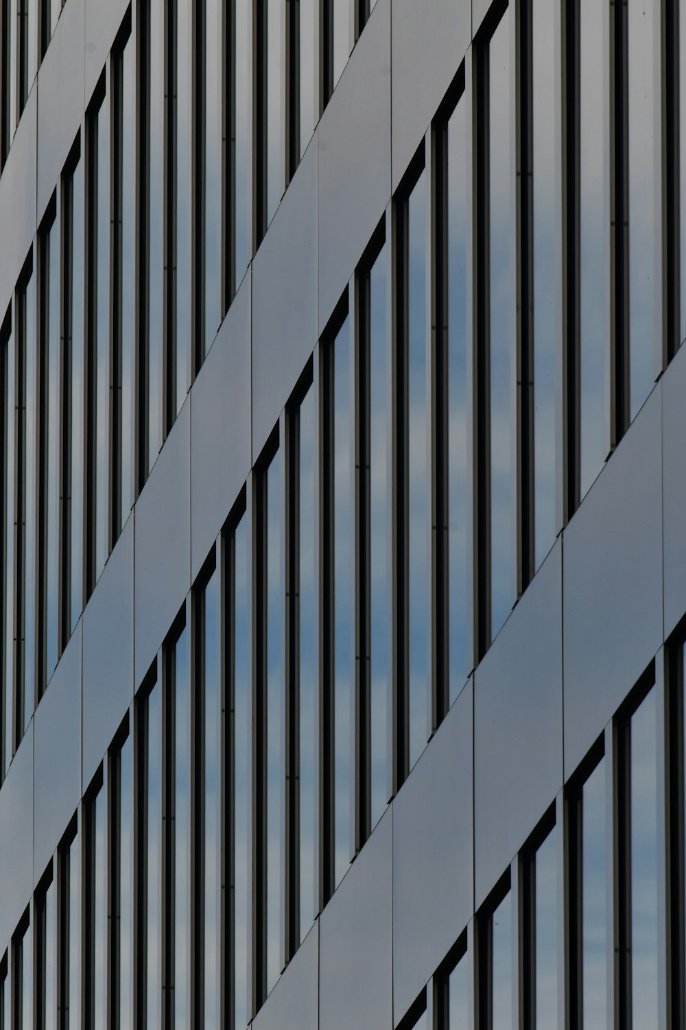 a plane flying in front of a tall building