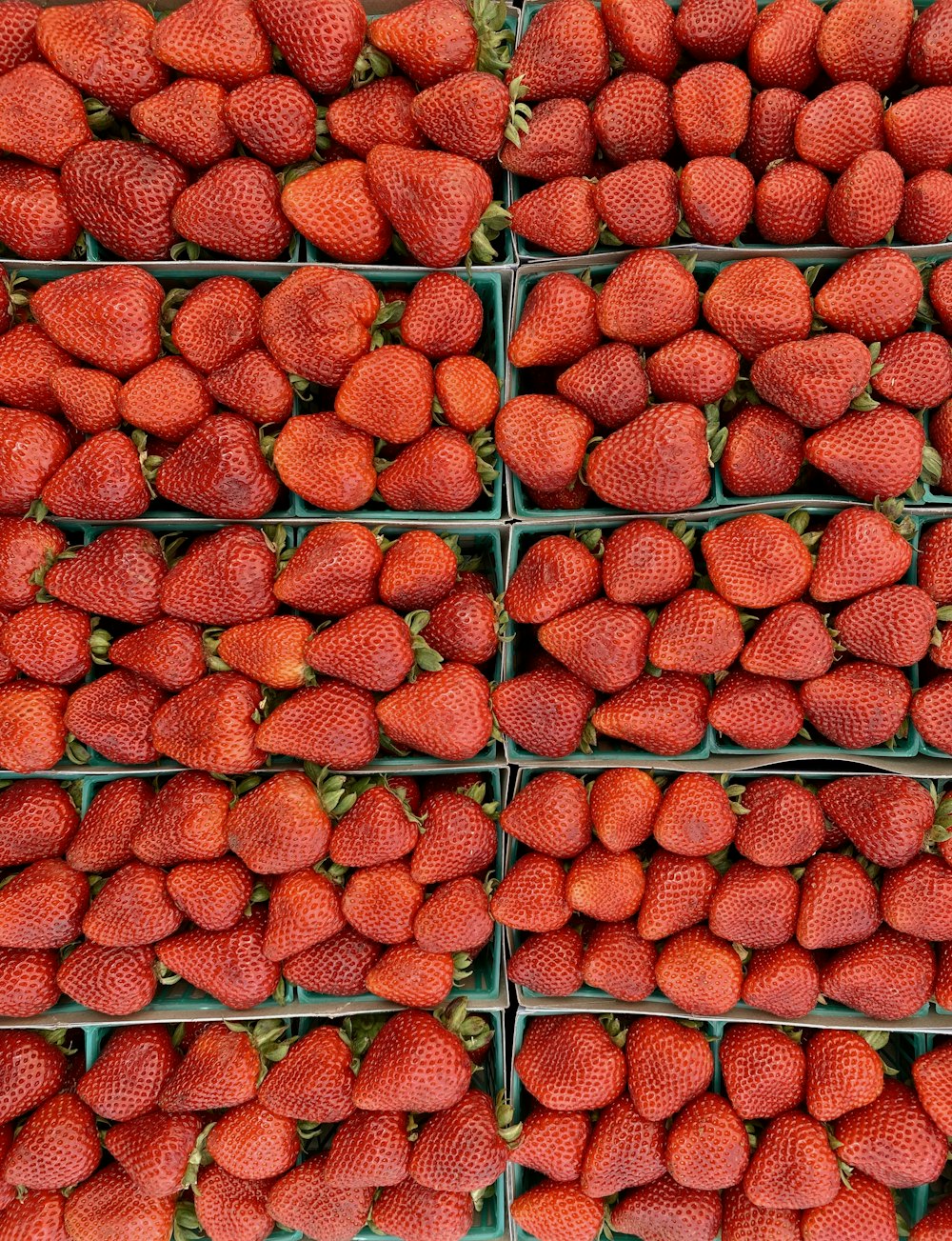 a bunch of baskets filled with lots of strawberries