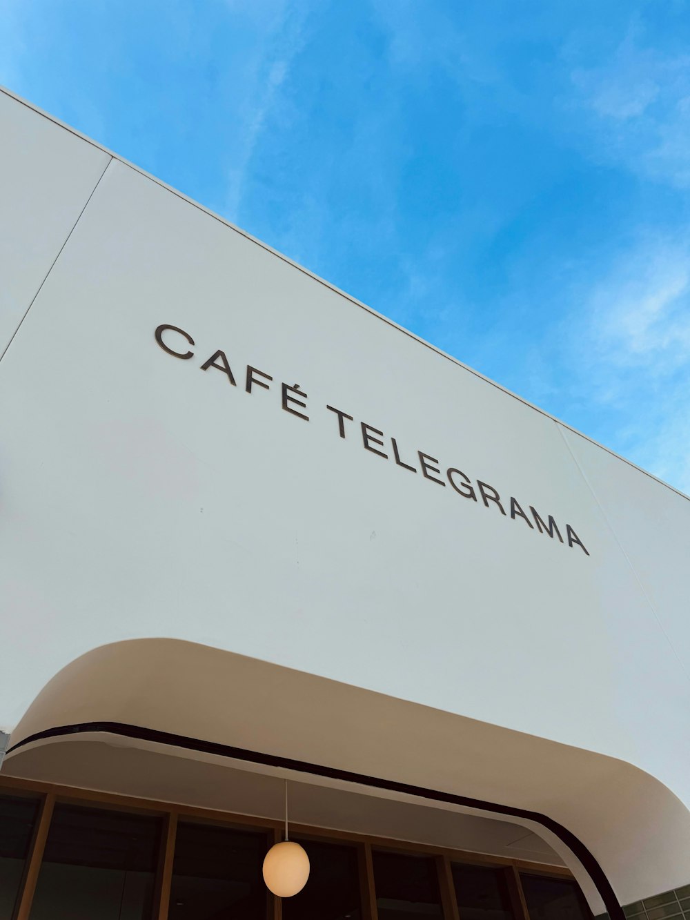 a white building with a sign that says cafe telepama