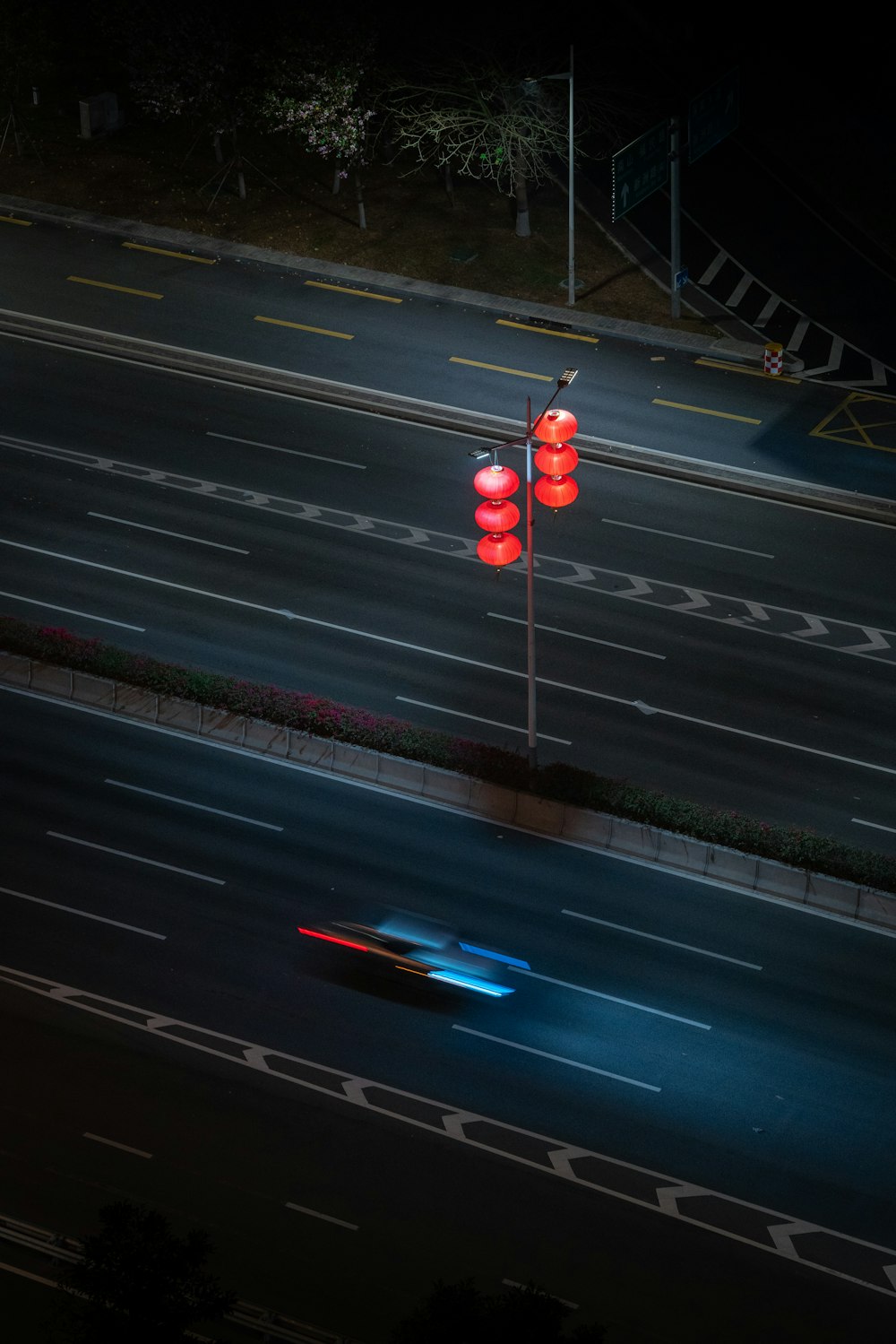 a car driving down a street at night