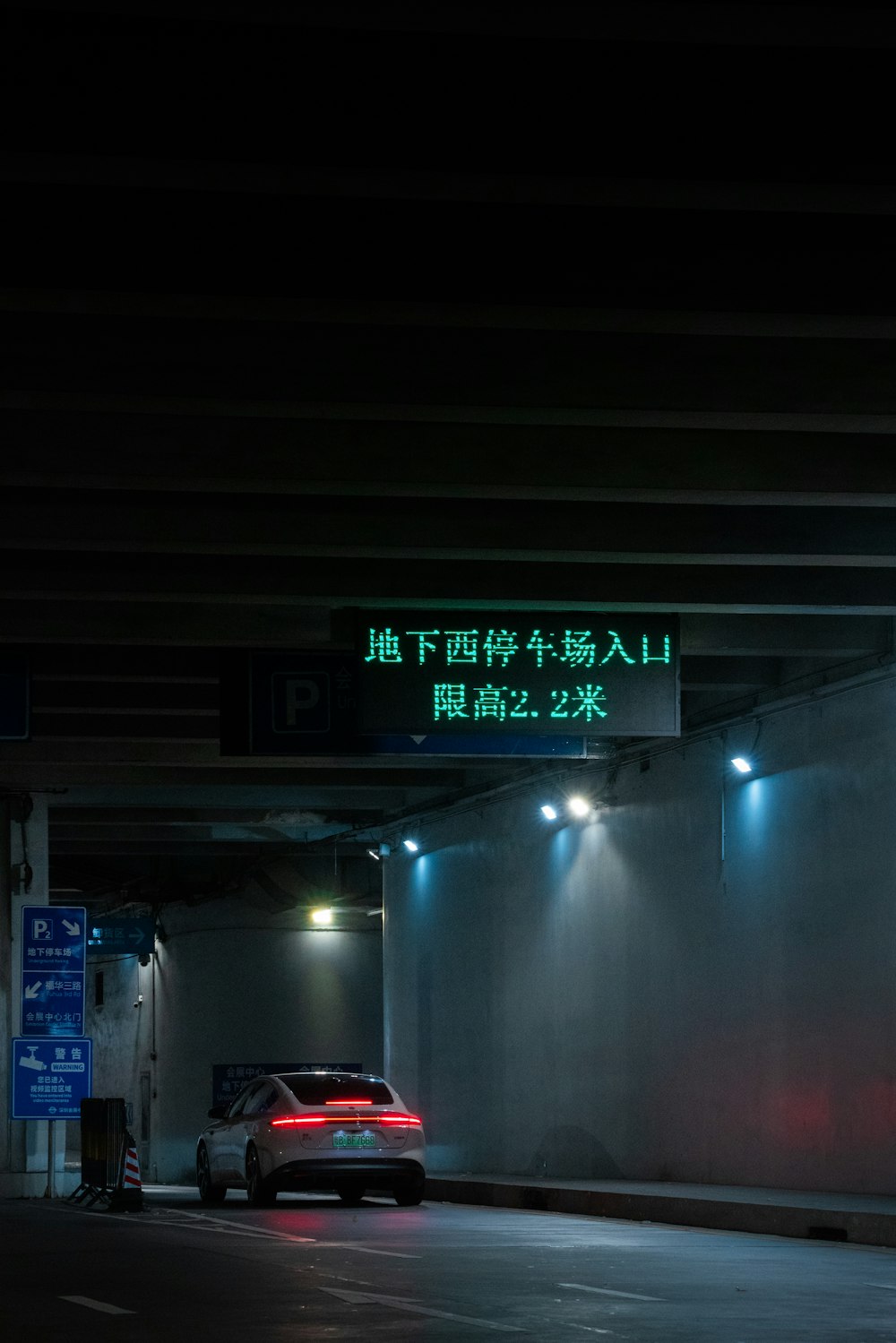 a car parked in a parking garage at night