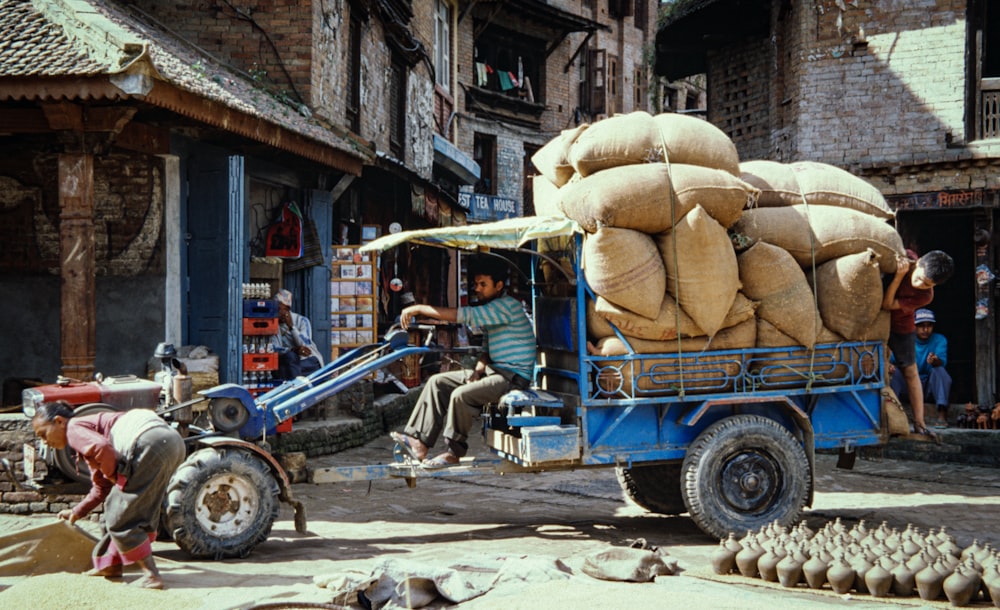 a truck with a load of sand bags on the back of it