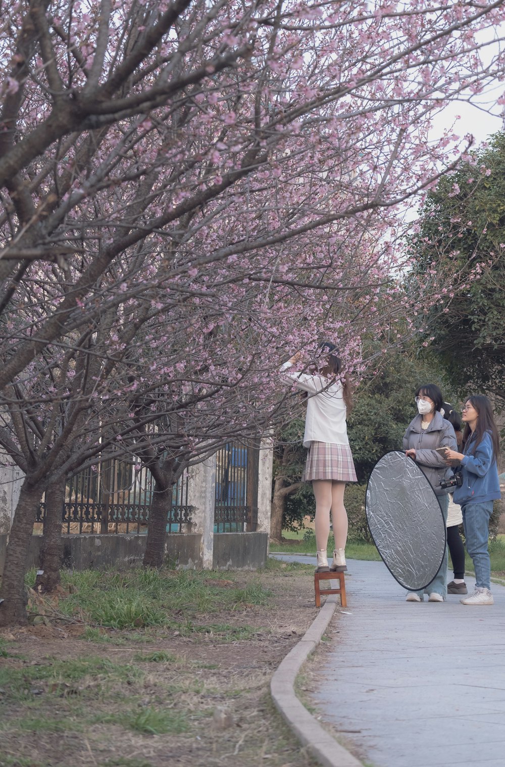 a woman in a white dress is standing on a round object