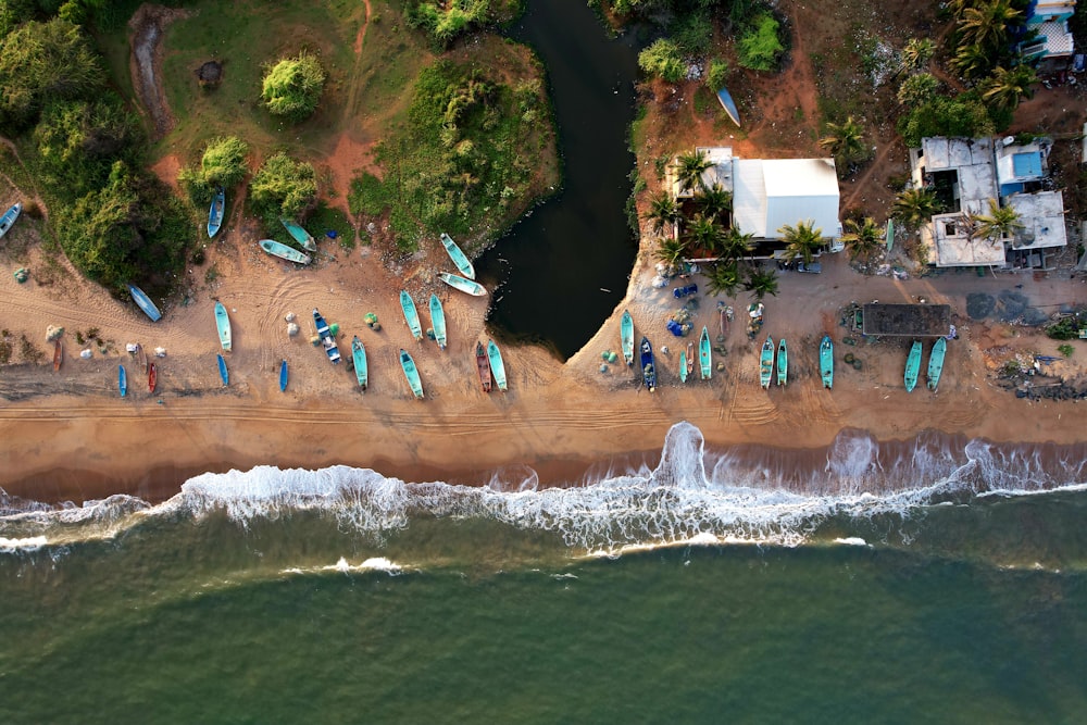 an aerial view of a beach with a lot of surfboards
