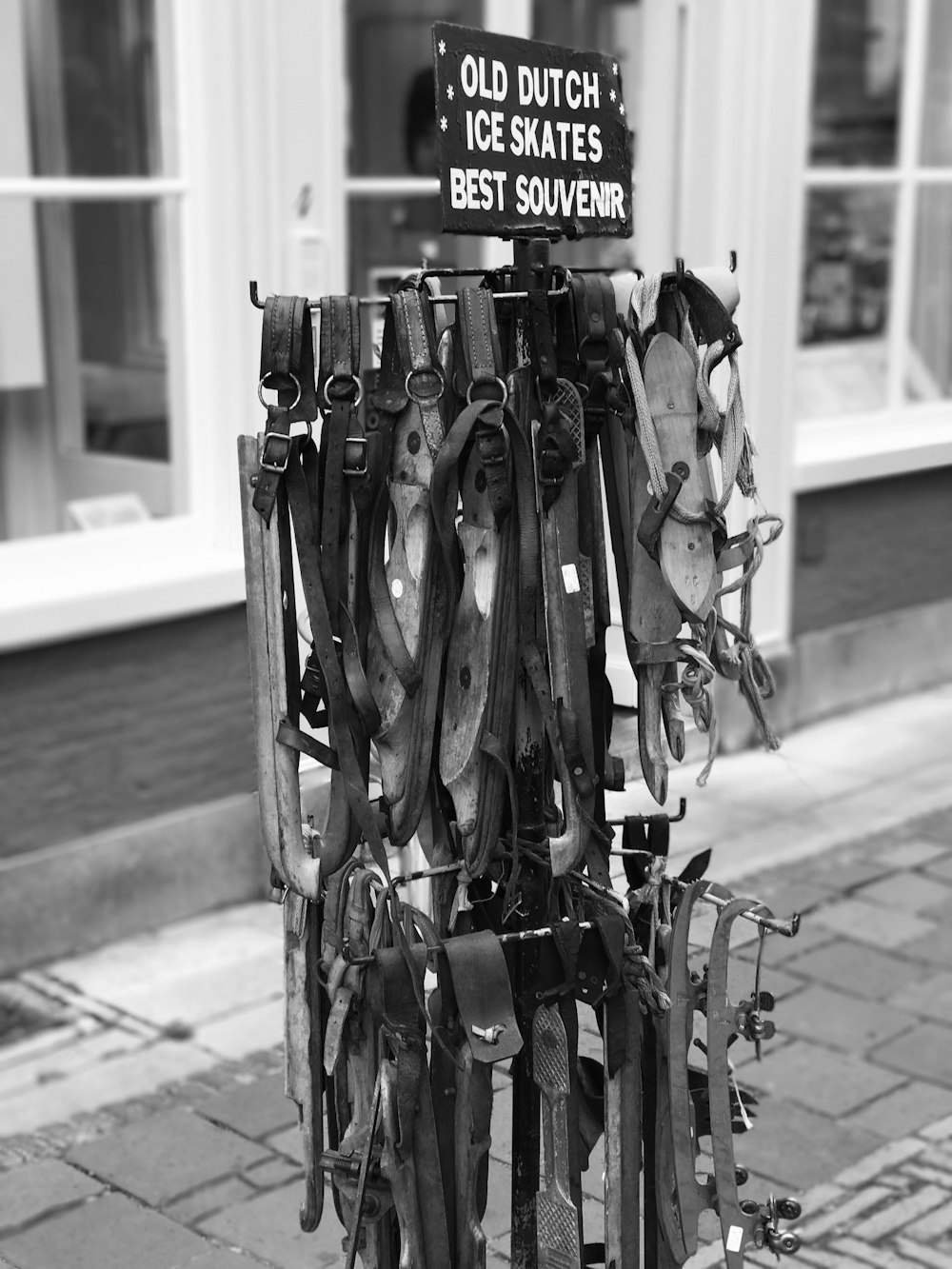 a bunch of skis are hanging on a pole