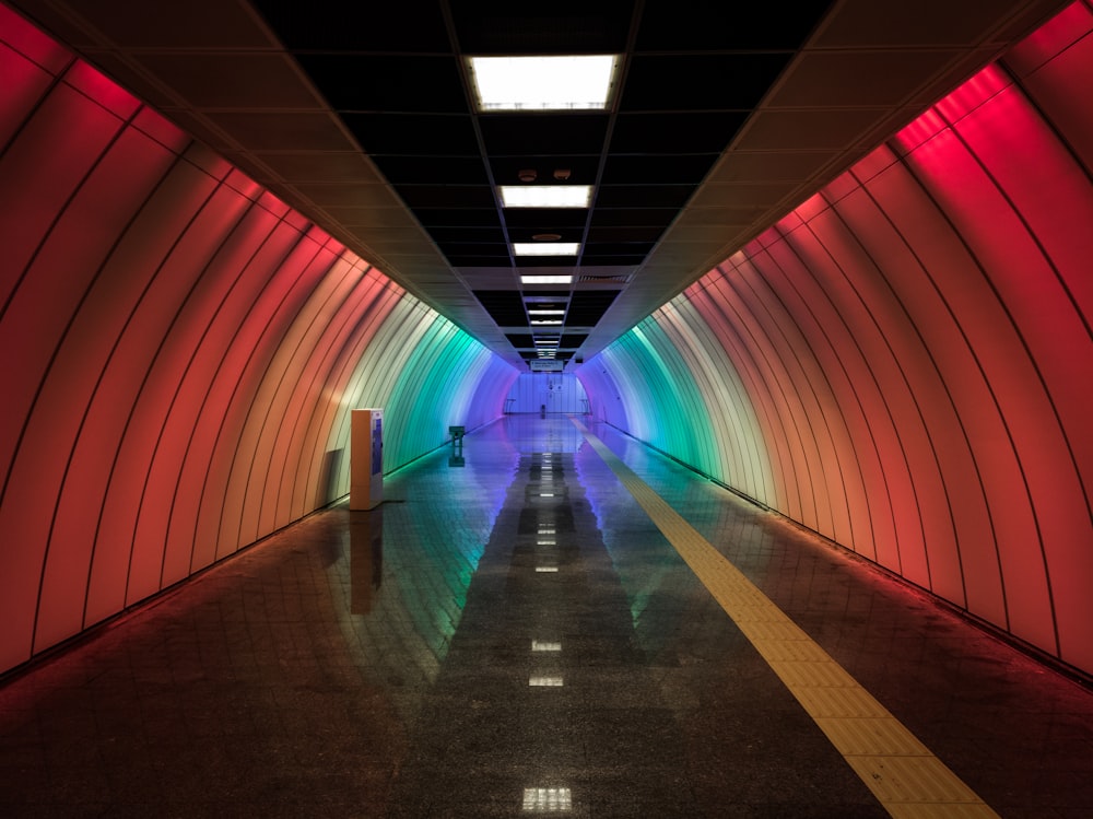 a long tunnel with a person walking through it