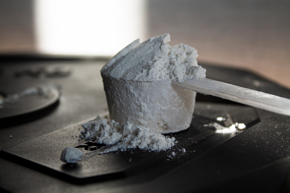 a scoop of white powder on top of a table