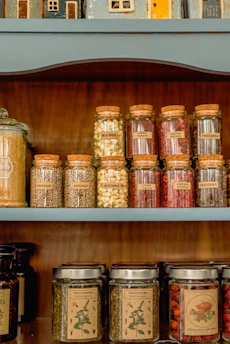 a shelf filled with lots of jars filled with food