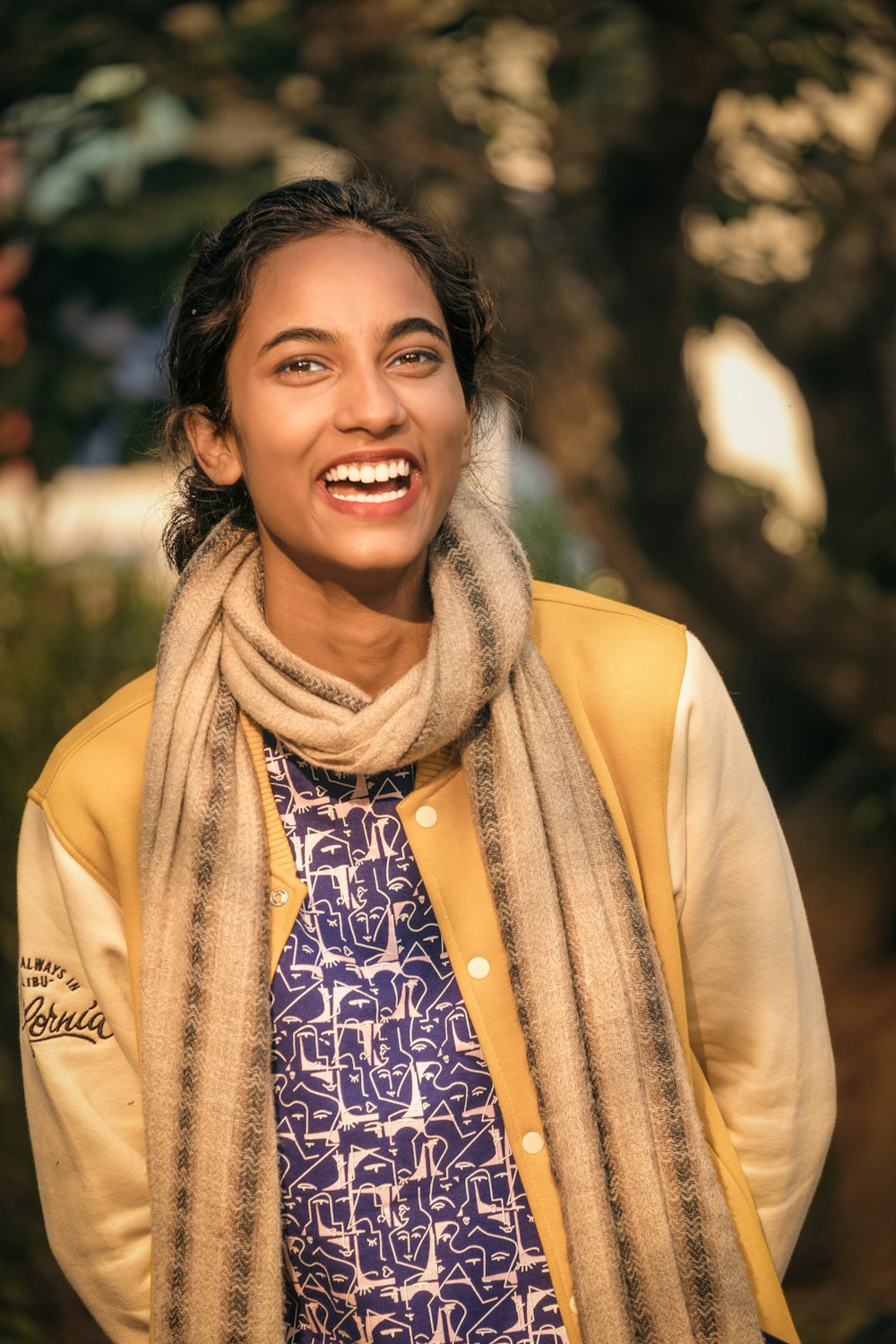 a smiling woman with a scarf around her neck