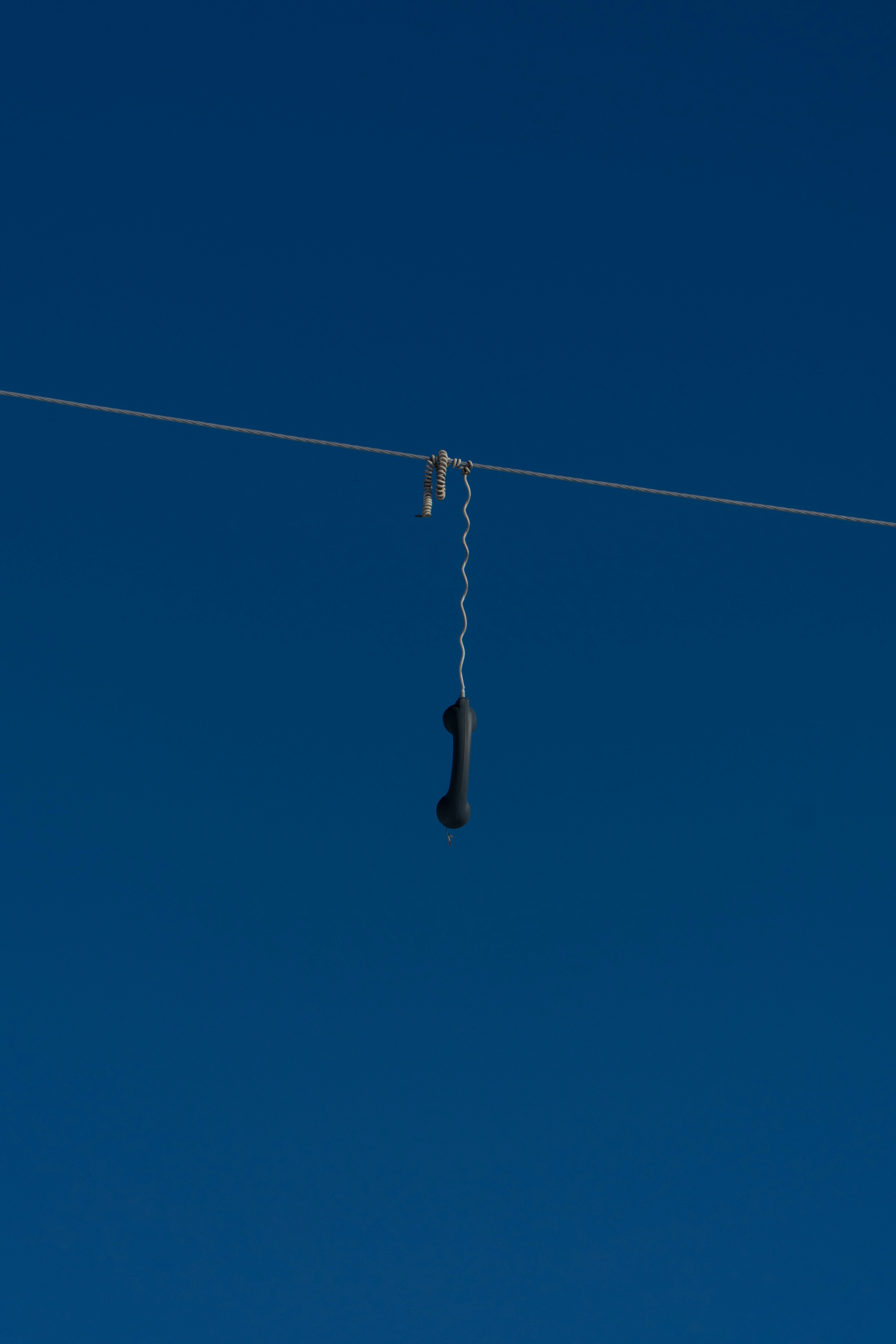 a pair of shoes hanging from a wire