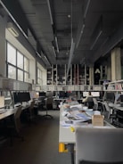 an office filled with lots of desks and computers