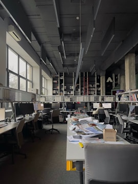 an office filled with lots of desks and computers