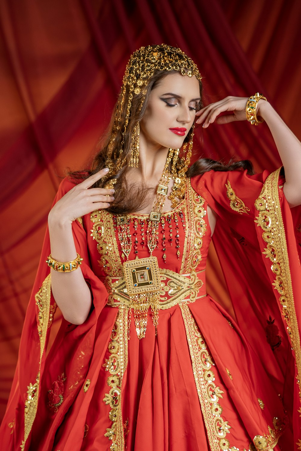 a woman in a red and gold costume