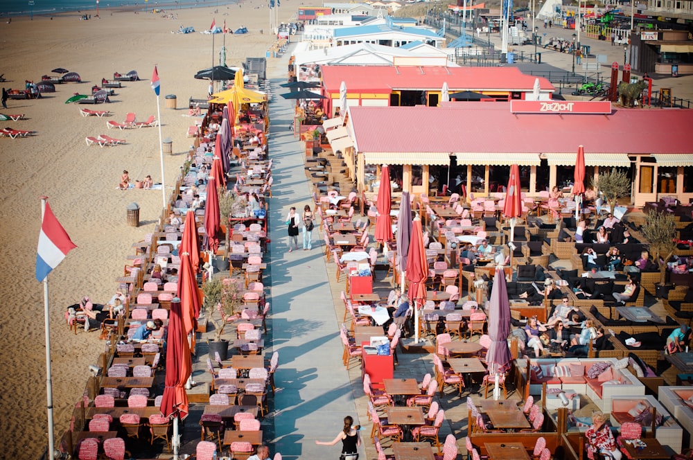 a beach filled with lots of tables and umbrellas