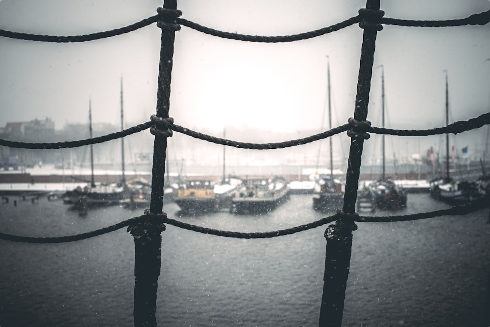 a view of a harbor through a wire fence