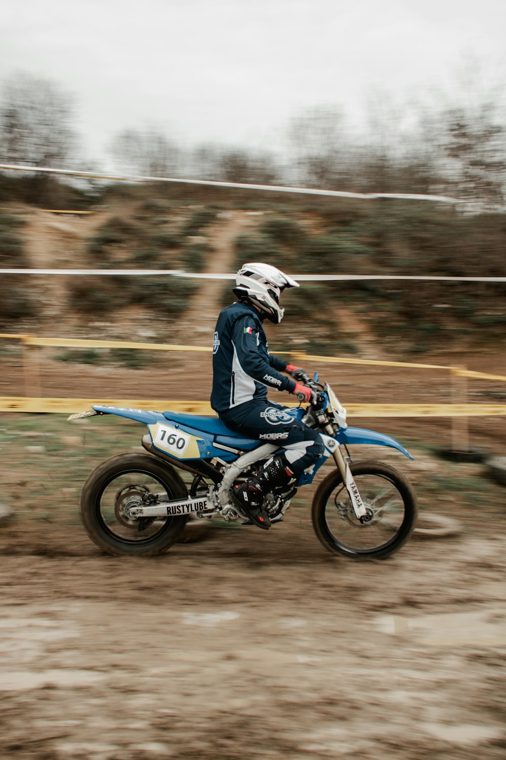 a person riding a dirt bike on a dirt road