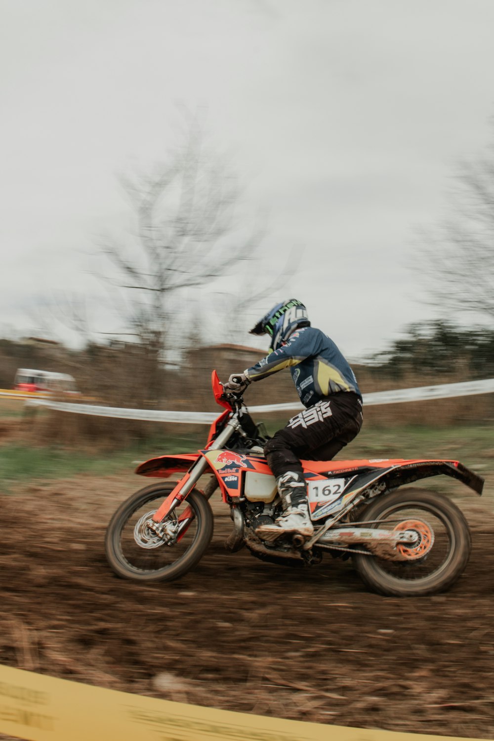 a man riding a dirt bike on top of a dirt field