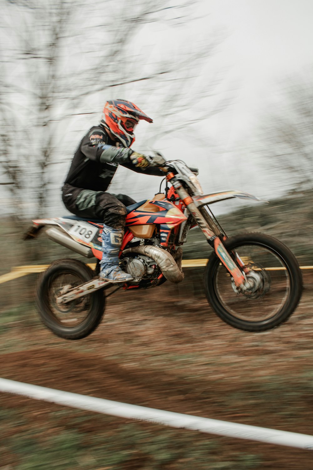 a person riding a dirt bike on a dirt road