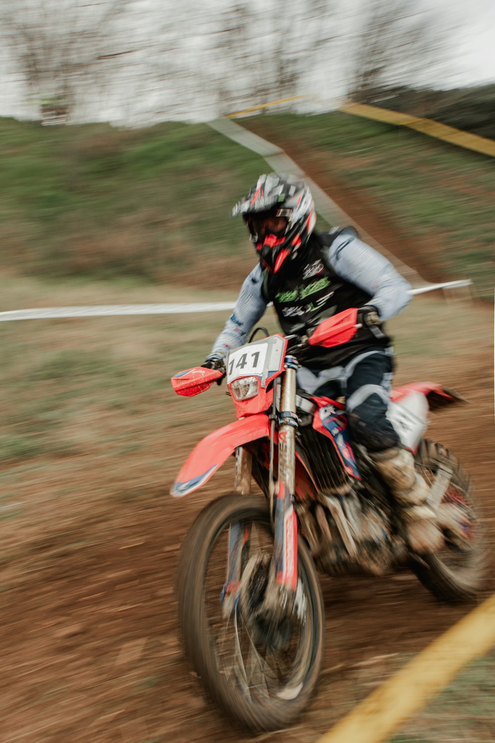 a person riding a dirt bike on a dirt track