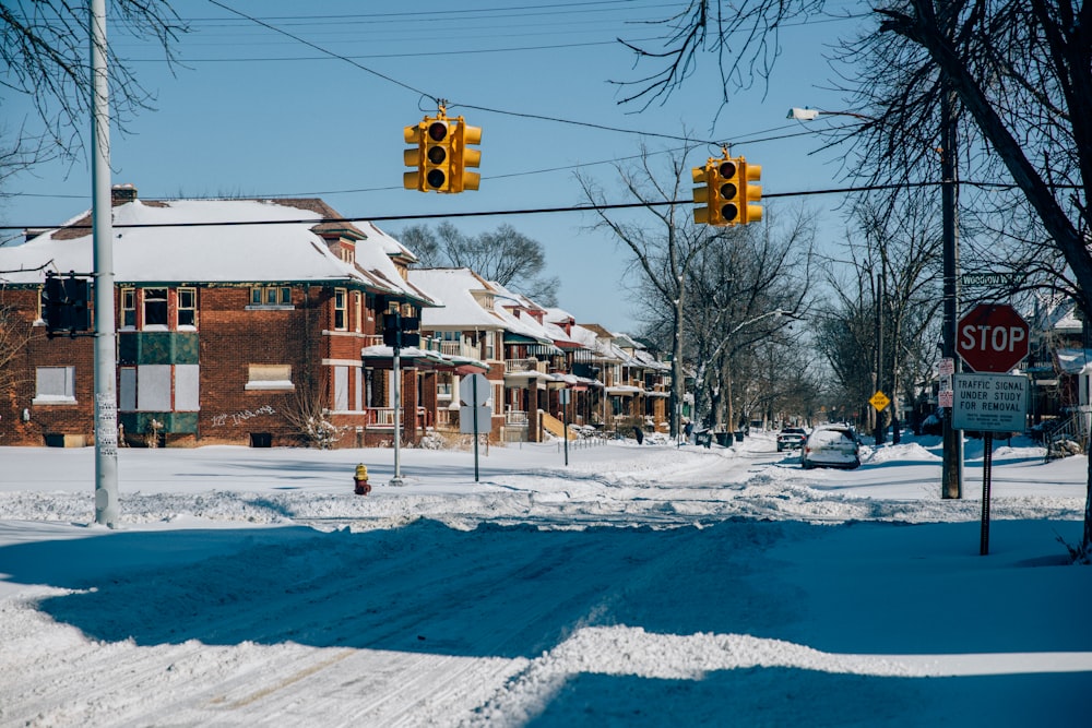 a street with snow on the ground and a stop light