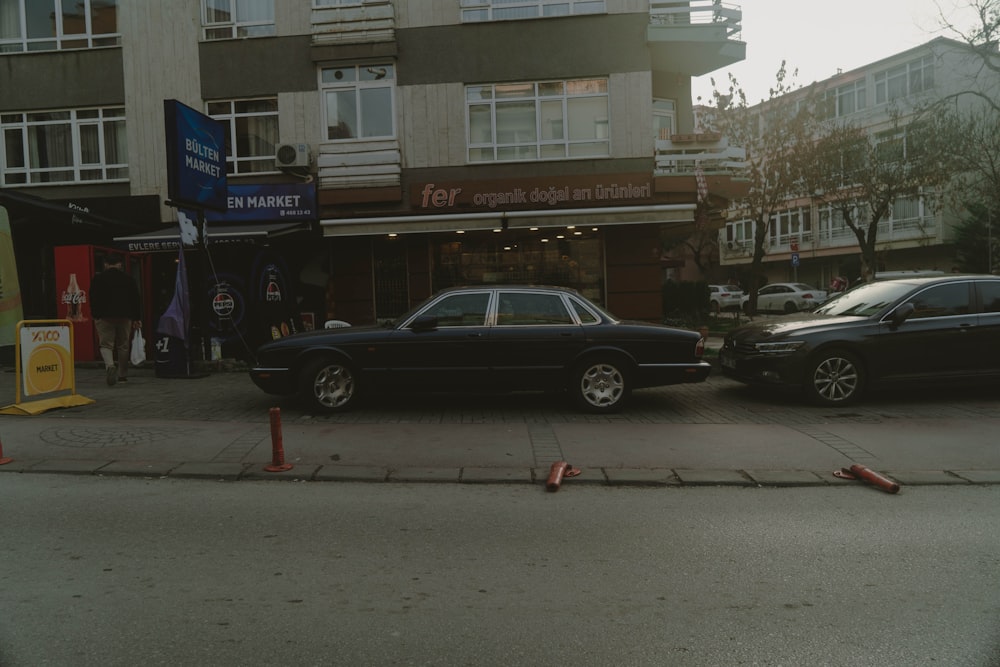 a couple of cars parked next to each other on a street