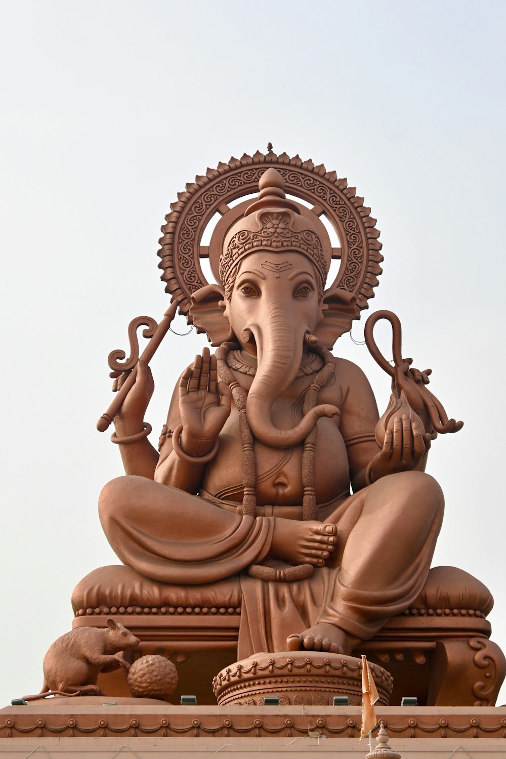 a statue of an elephant sitting on top of a building