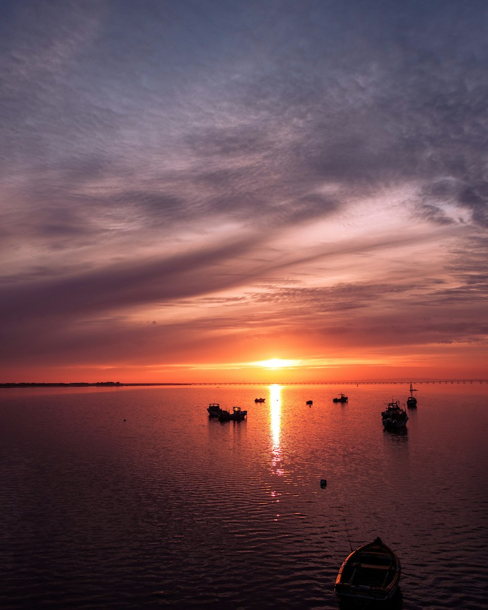 a group of boats floating on top of a large body of water