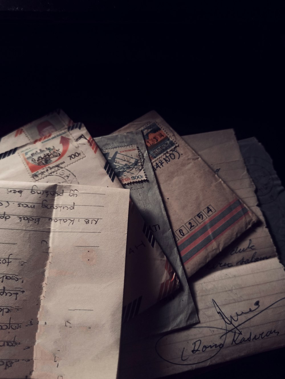 a pile of mail sitting on top of a table