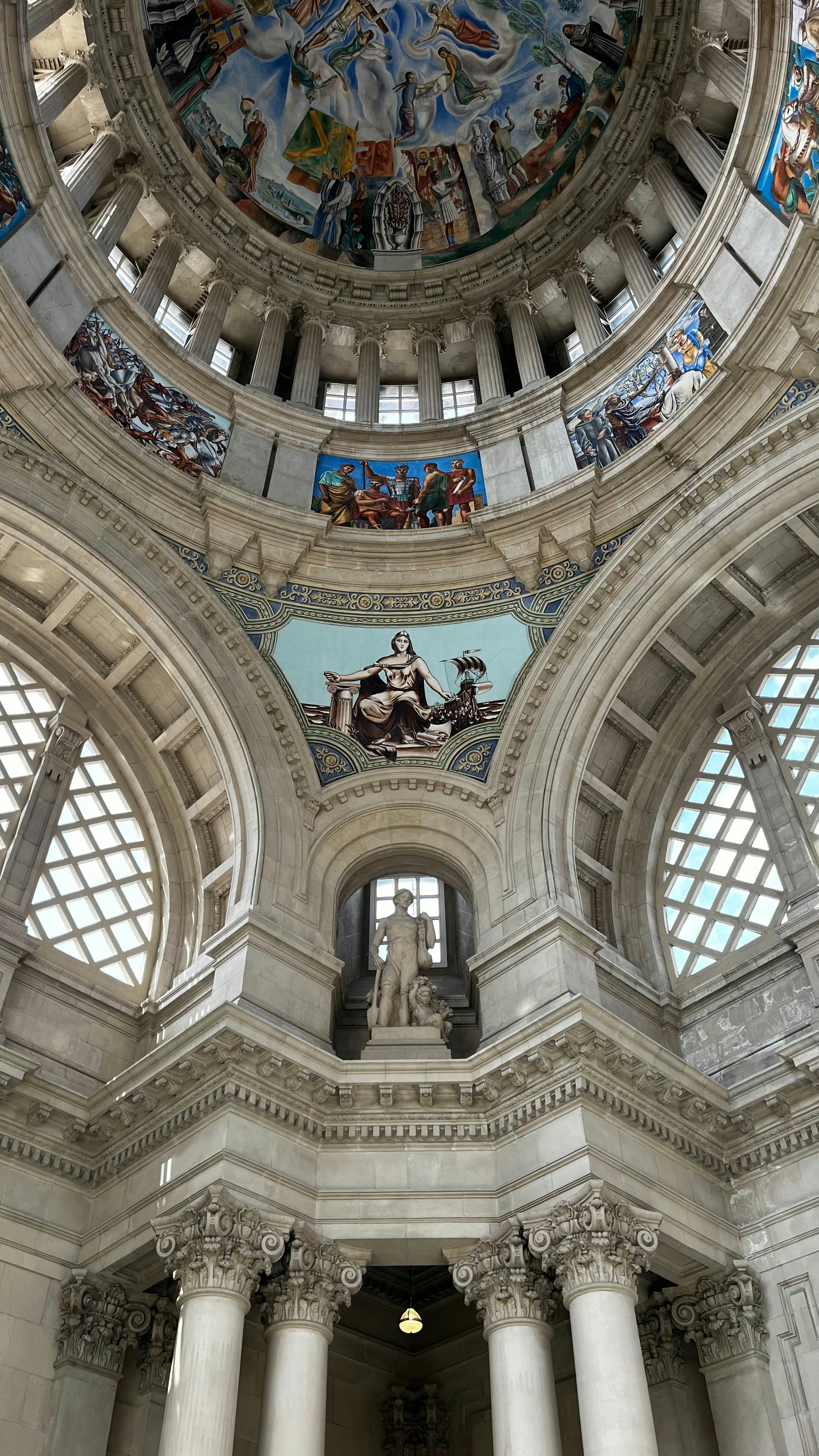 the ceiling of a large building with many paintings on it