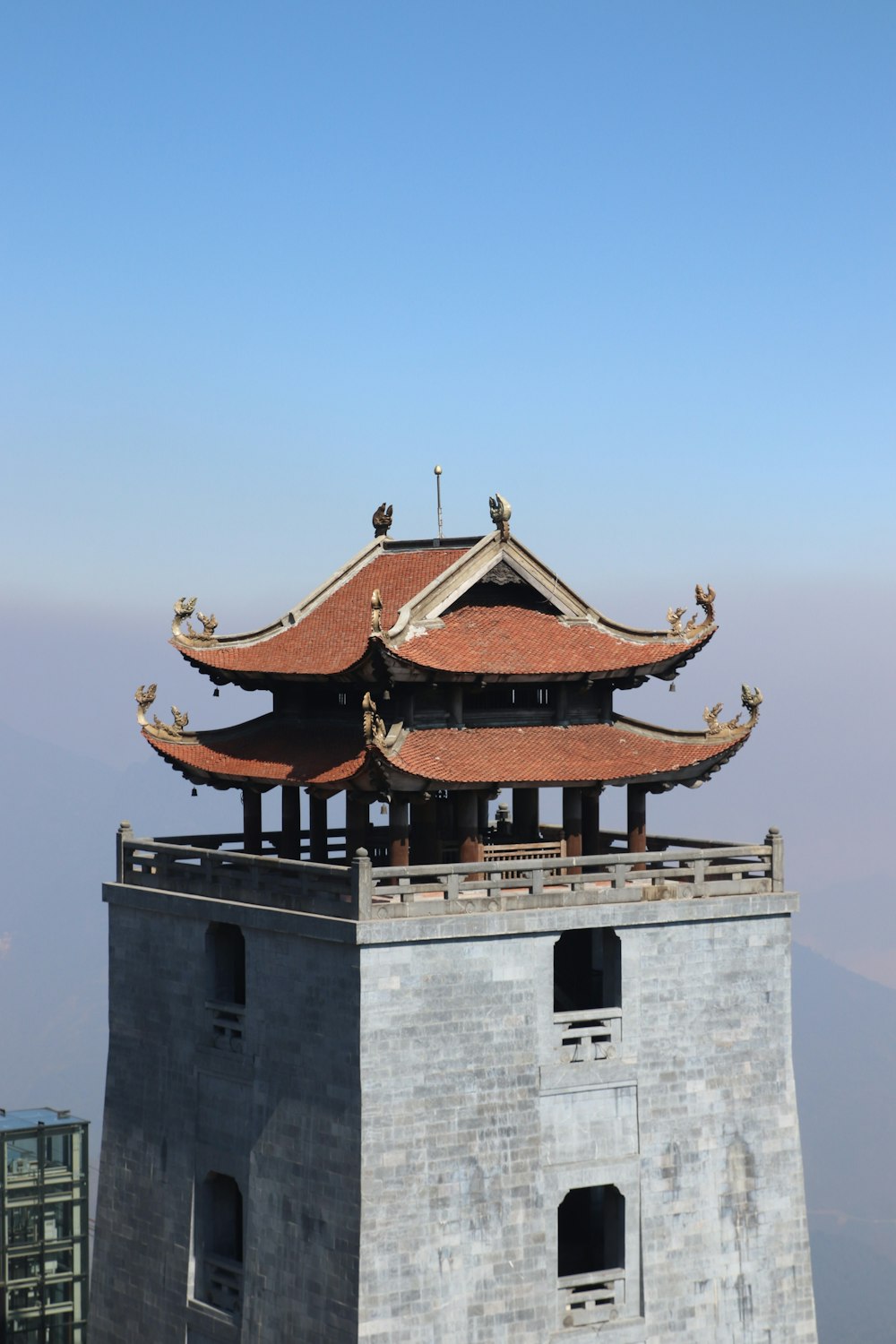 a tall building with a red roof on top of it