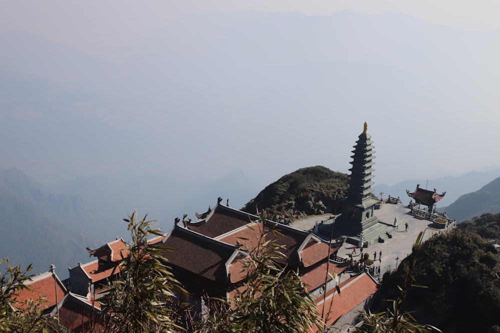 a building on top of a hill with mountains in the background