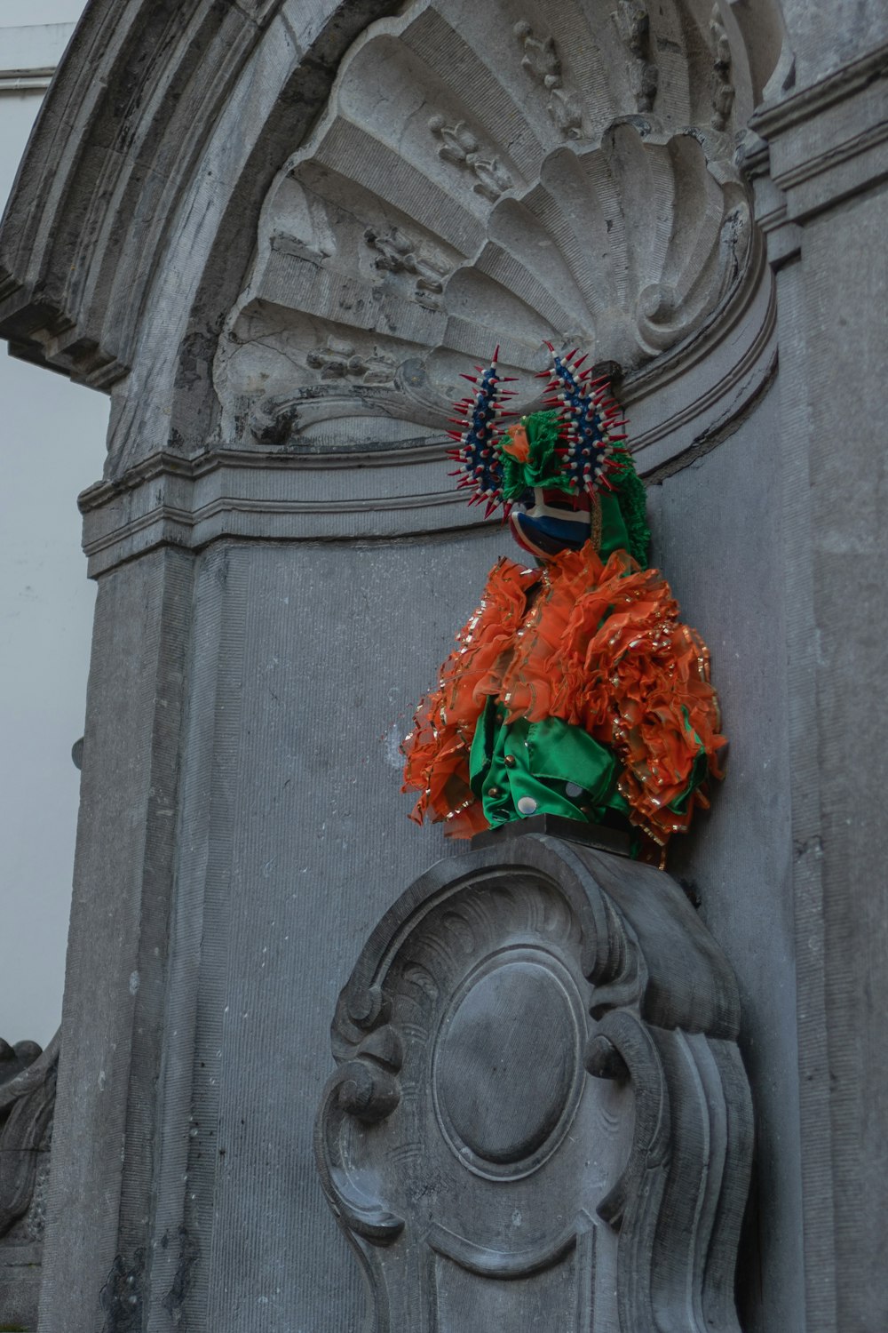 a statue of a woman with a green headdress