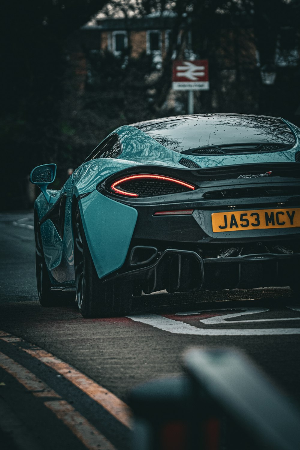 a blue sports car parked on the side of the road